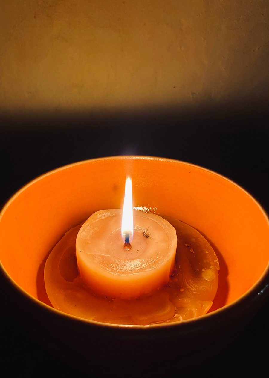 A small fire burning on bare earth at night